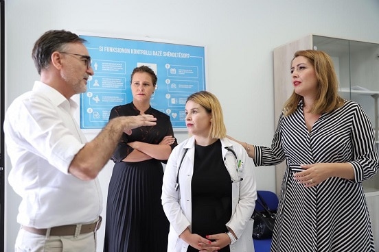 Director of 'Health for All' project Besim Nuri discussing with Albania's Minister of Health Ogerta Manastirliu at the health centre in Sauk, Tirana