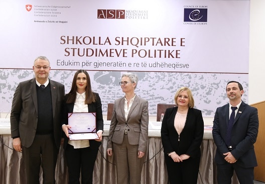 Swiss Ambassador in Albania Adrian Maître (left) handing out certificates to graduates of the Academy of Political Studies. 