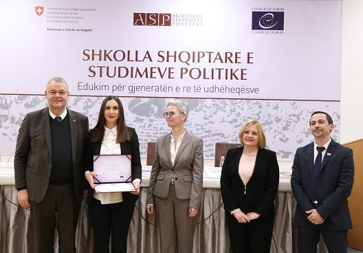 Swiss Ambassador in Albania Adrian Maître (left) handing out certificates to graduates of the Academy of Political Studies.