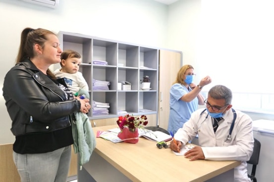 Patients and health personnel at the newly reconstructed health centre in Ishëm, Albania. 