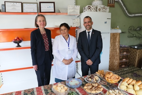 Ambassador Muriel Peneveyre and Alberto Hernandez with a project beneficiary in her bakery