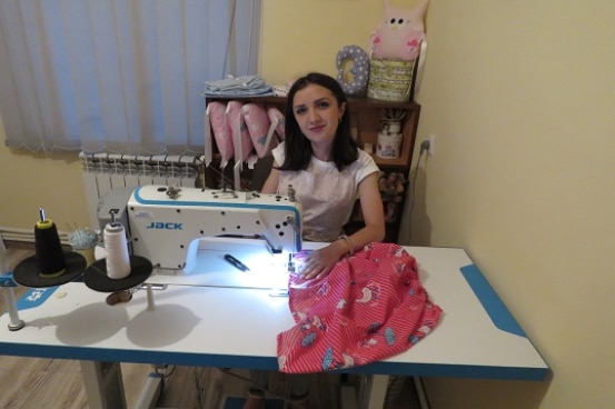 A young armenian girl is sewing