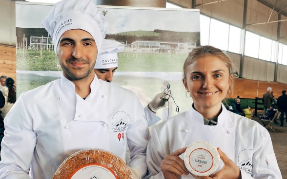 Sandro holds cheese in his hands