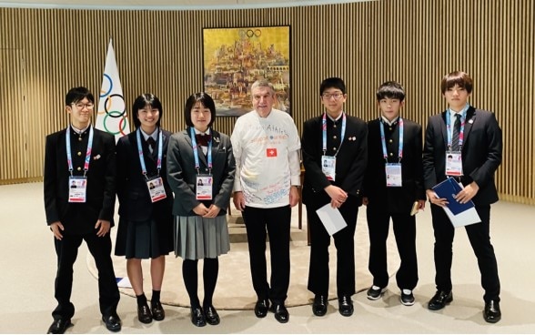 The President of the International Olympic Committee, Mr. Thomas Bach and the six students from the Tohoku region at Olympic house 