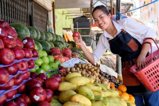 Katay shopping for fresh fruit for the restaurant.