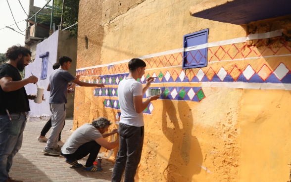 Qattana local community members are beautifying their village through repairing and painting the walls