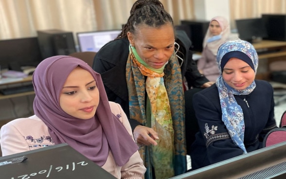 SDC Director General, Patricia Danzi, engaging with two young women receiving training on online freelancing in the UNRWA TVET center in Gaza supported by SDC