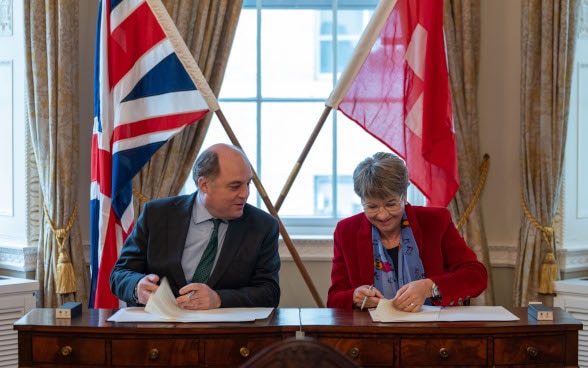 a man and a woman signing documents