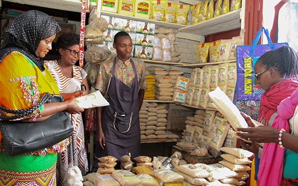 The company owner with staff and customers in her store in Bujumbra.