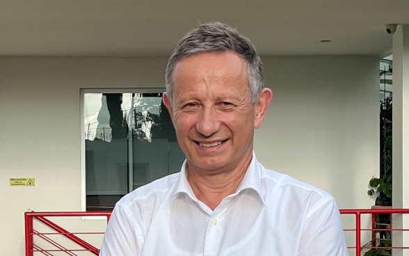 Christoph Graf standing in front of a building