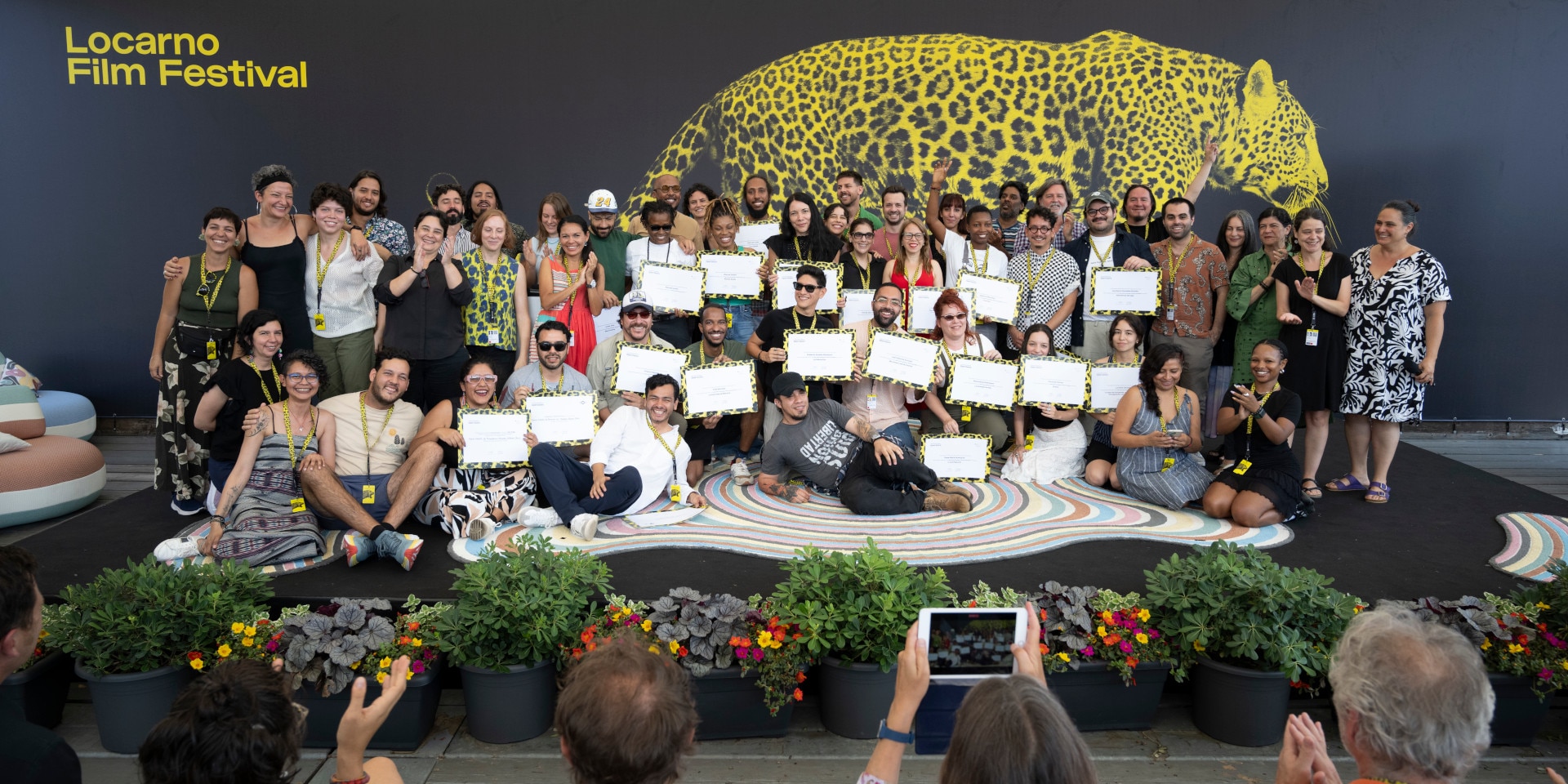 All of the participants of Open Doors 2024 are gathered on stage.