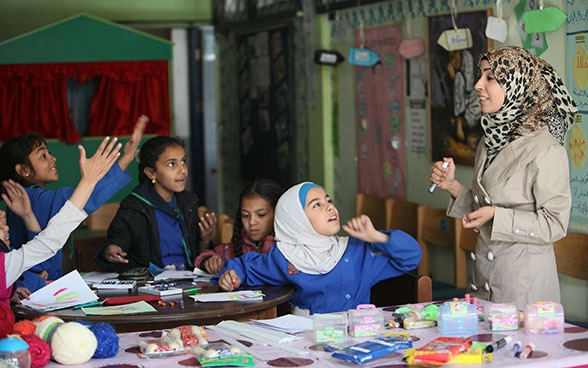 Girls in class in Khan Dunnoun in Syria listening attentively to their teacher.