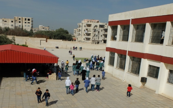 A school playground with children.