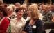 Two annual conference participants in the audience having an animated discussion.