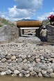 A group of men standing next to the recently built outlet of a drainage canal.