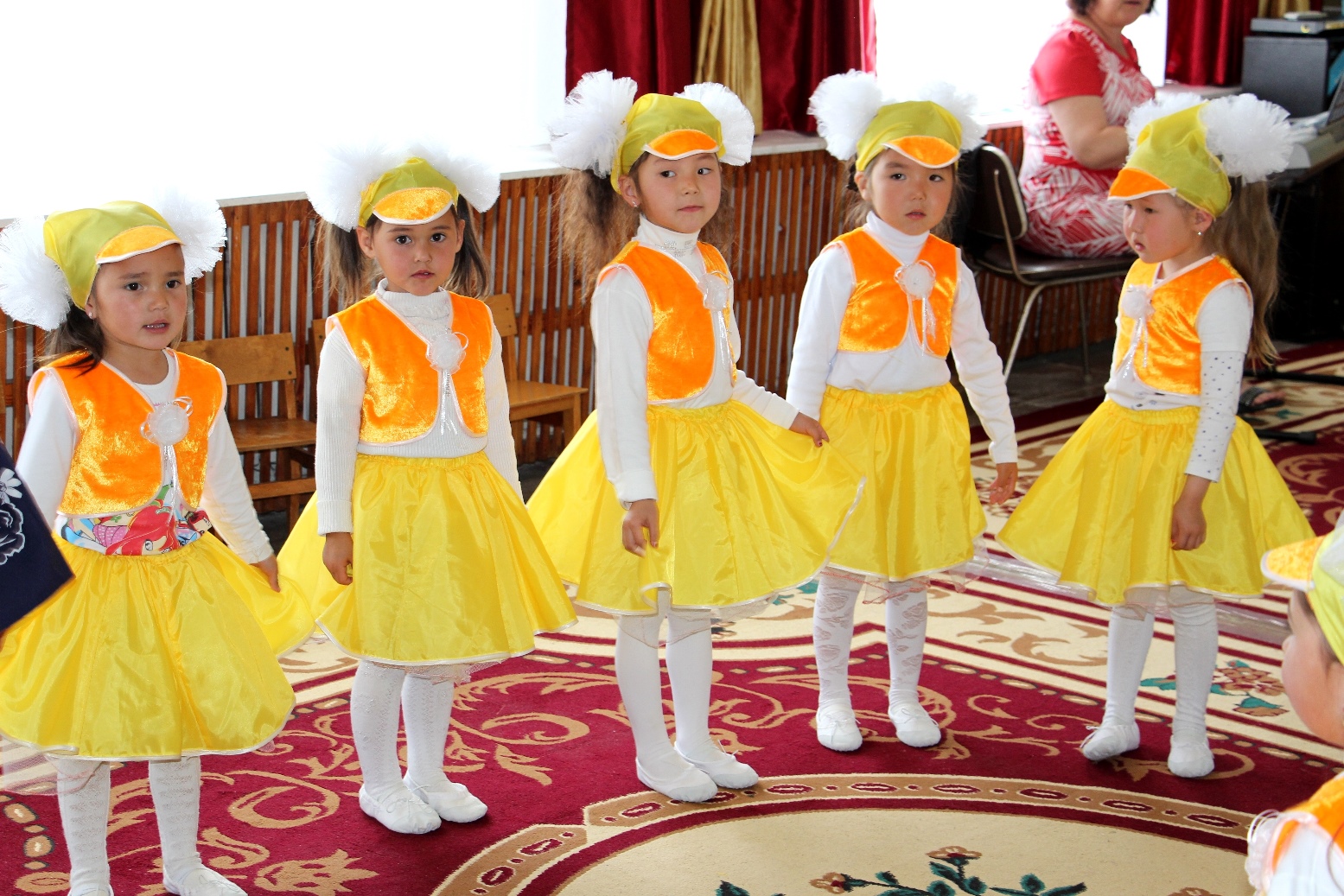 Cinque ragazze con un abito giallo per la festa di inaugurazione del nuovo asilo