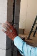 An Indian worker builds a wall with LC3 blocks.