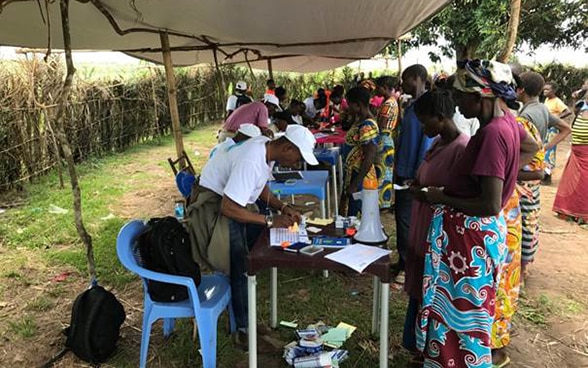 Staff checking the names of beneficiaries.