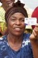A farmer shows her Eco-Farmer identification card.
