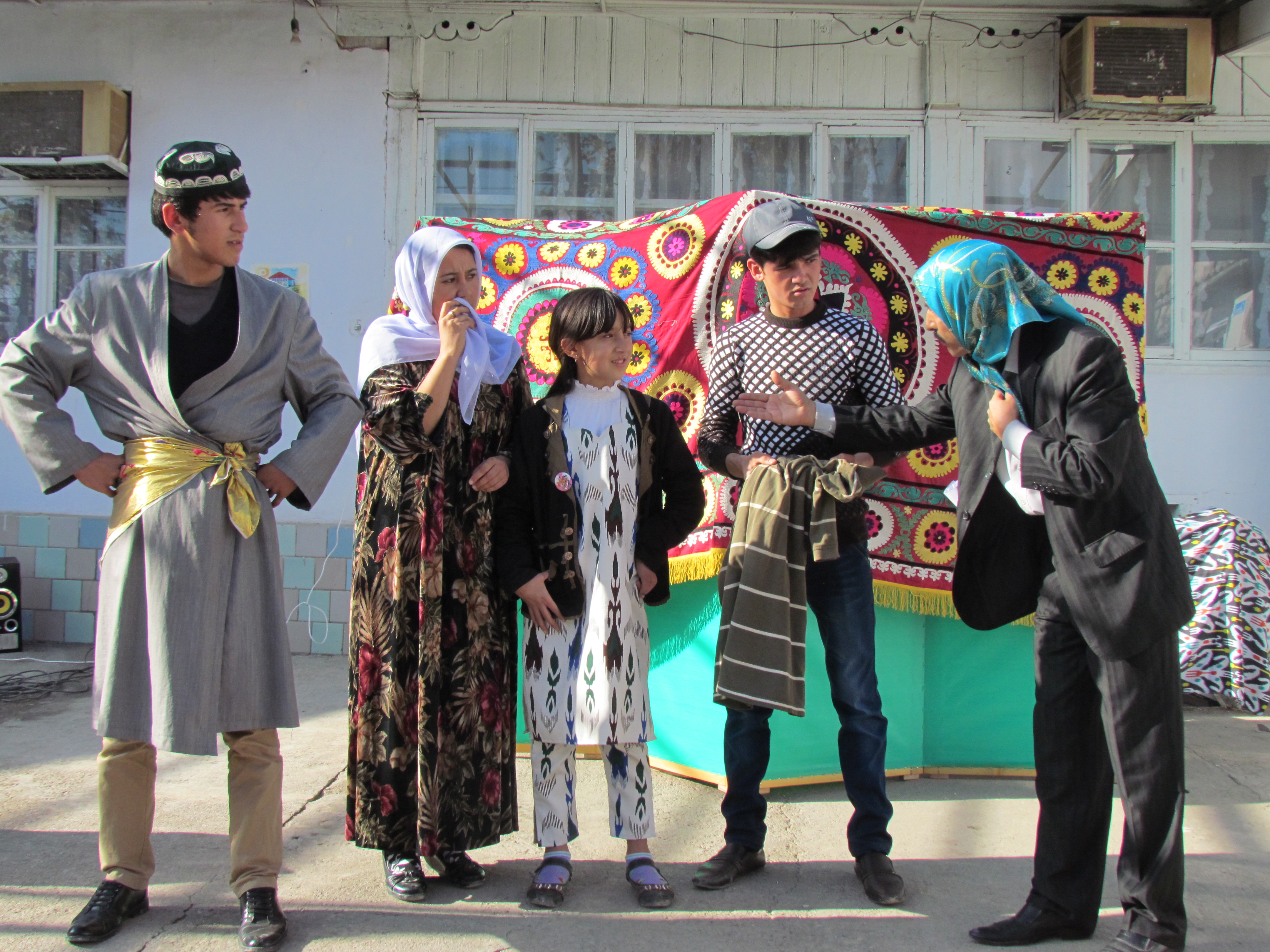 Five actors miming a scene from everyday life.