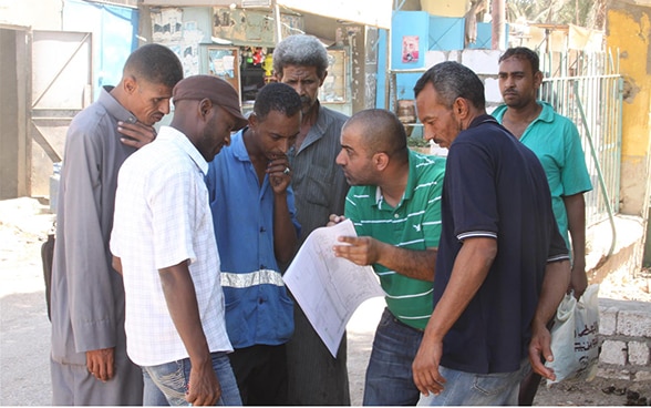 A group of employees from the Aswan Water and Sanitation Company learns how to read maps, a skill that will help them maintain the water supply network more effectively.