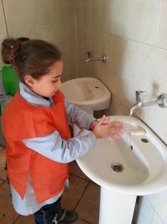 Two girls washing their hands at the new sinks.