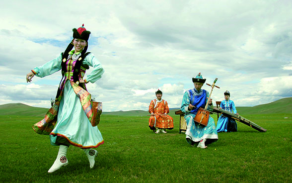 Dancer performing a traditional Mongolian dance to the sound of a horsehead fiddle.