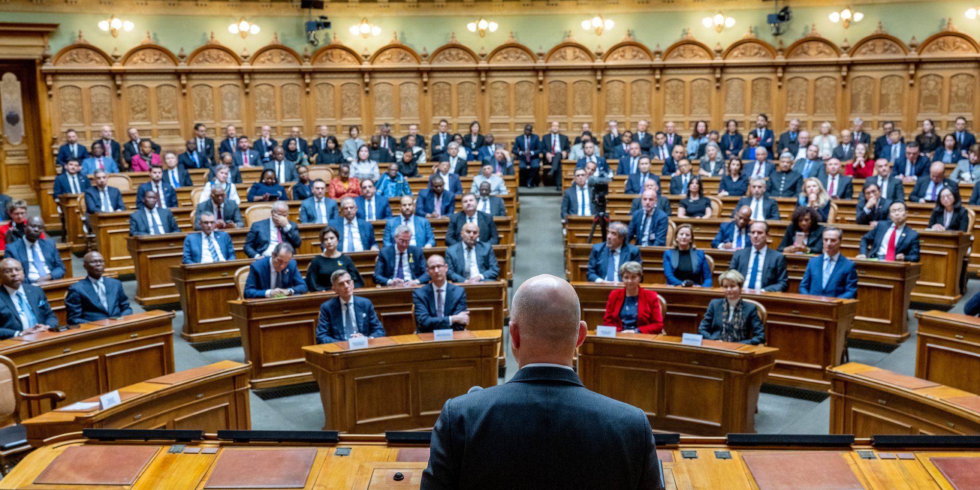 The foreign ambassadors listen to President Alain Berset speaking at the 2023 New Year's Reception in the National Council Chamber.