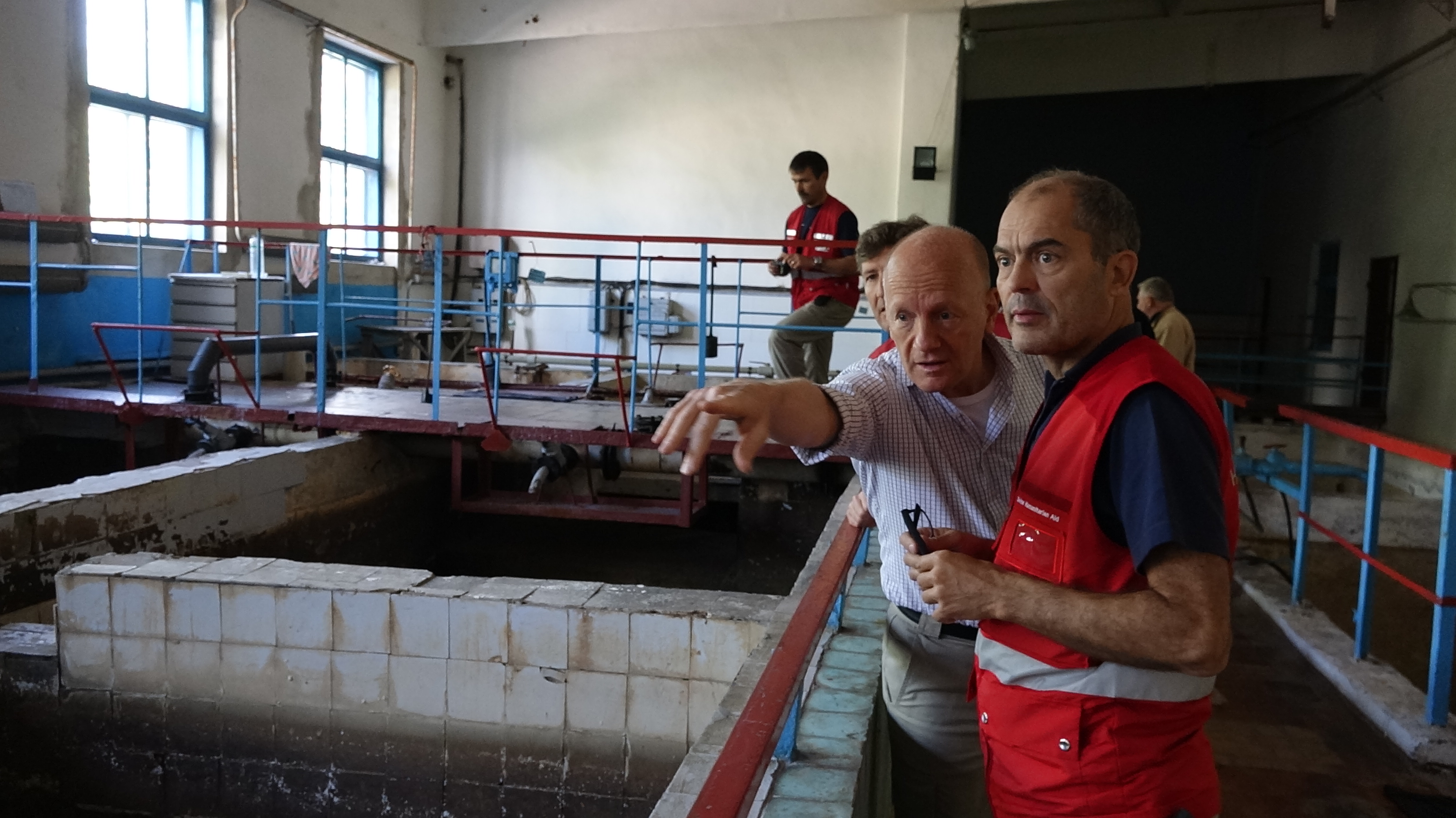 Swiss experts inspecting tanks at a waterworks. 