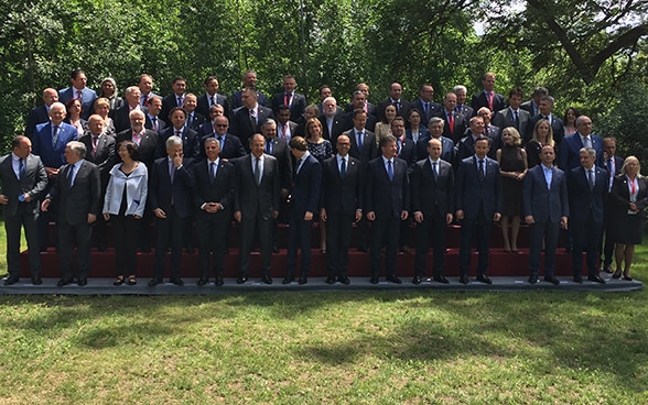 The Foreign Ministers of the OSCE gather all together on the grass for a group photography