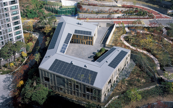 Aerial view of the embassy showing the solar panels on the roof and the gardens. 