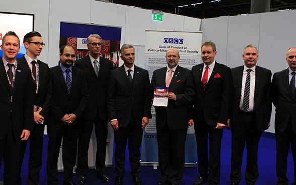 Co-Editors and selected authors of the Commemorative Publication together with the OSCE CiO Didier Burkhalter and the OSCE Secretary General Lamberto Zannier – from left to right: LtCol Thomas Schmidt, Mr Fabian Grass, Col Prasenjit Chaudhuri, Col (GS) Hans Lüber, CiO Didier Burkhalter, Sec Gen Lamberto Zannier, LtCol Detlef Hempel, Dr. Alexandre Lambert, Col (GS) Anton Eischer