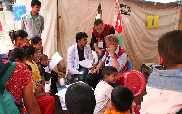 A local doctor and two Swiss aid workers register patients for admission to Gorkha District Hospital.