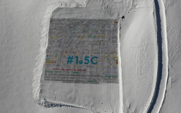 On the Aletsch Glacier lies the largest postcard in the world. It says "STOP GLOBAL WARMING # 1.5 °C" and "WE ARE THE FUTURE GIVE US A CHANCE". 