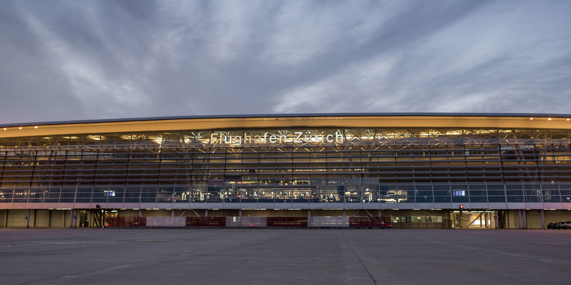 The airfield at Zurich airport with the airport building in the background.