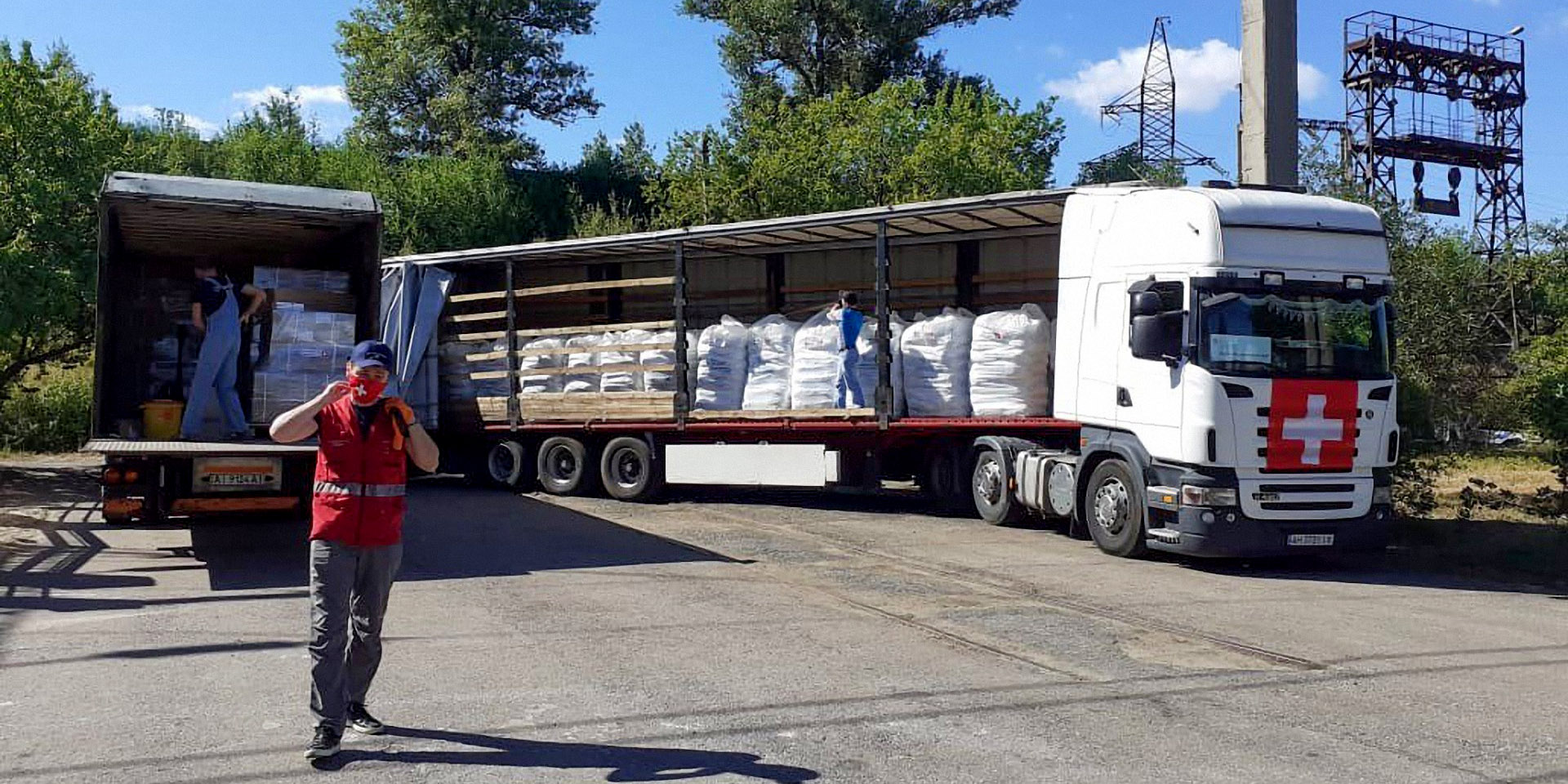  Swiss humanitarian aid logisticians load relief supplies into a truck. 