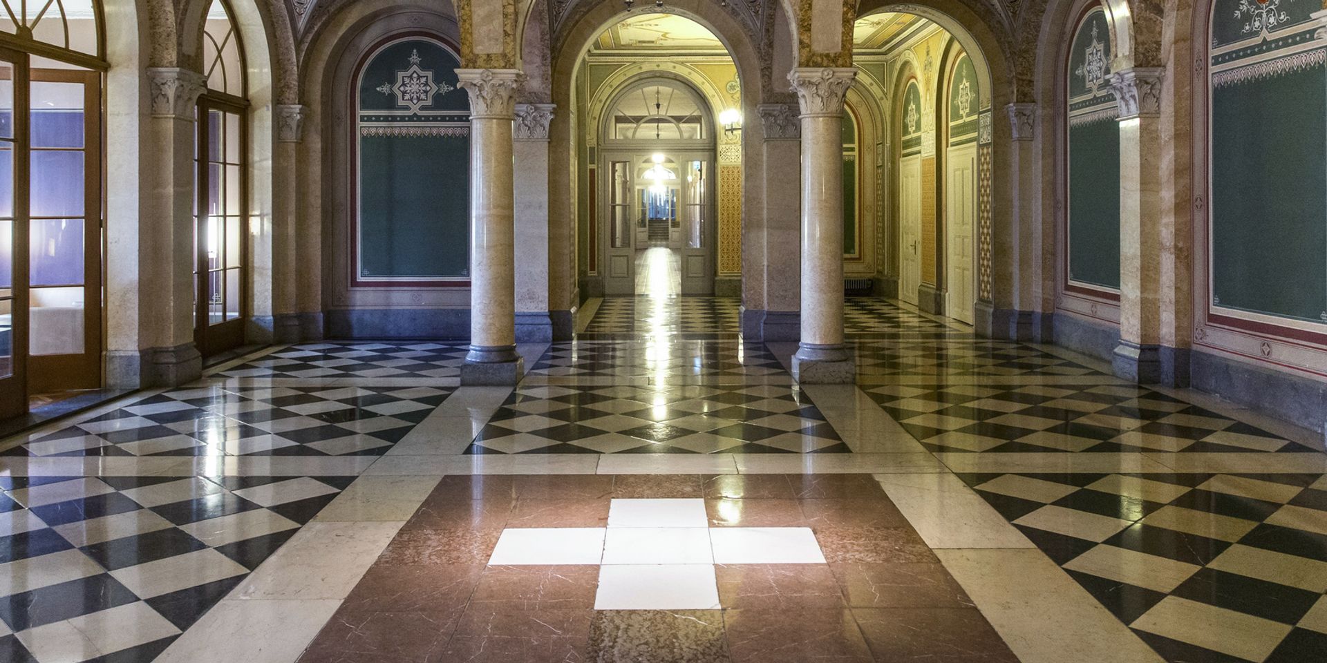 View of the interior of the West House of the Federal Government with a Swiss cross on the floor. 