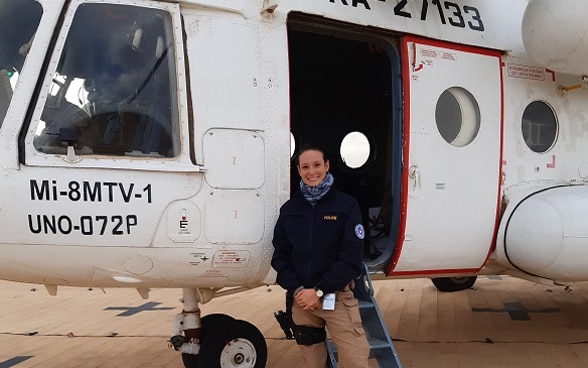  Photograph of a woman police officer from Switzerland standing in front of an aircraft in Mali