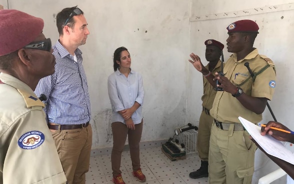 Two ICoCA representatives talk to representatives of a private African security companies.