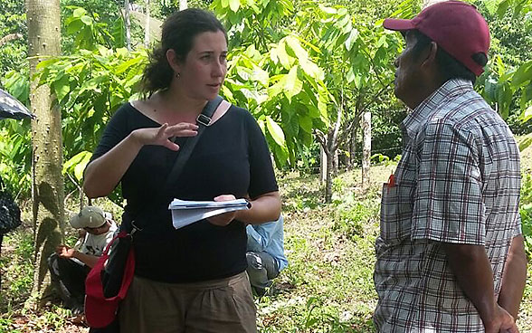 Andrea Inglin talks to cocoa farmers in Nicaragua as part of a project visit during her mission.