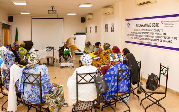 Women are seated in a circle. 