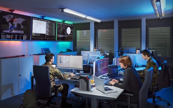 Military personnel working on computers.