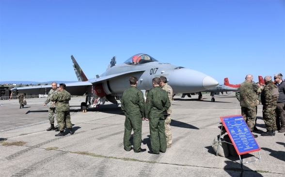 A military aircraft at an airport.