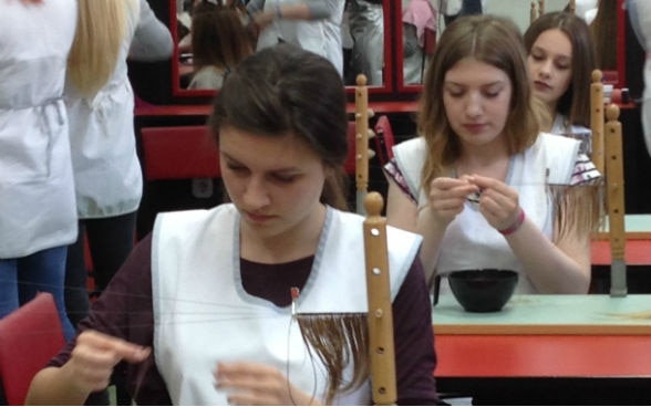 Apprentices sewing wigs