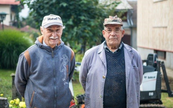 Two elderly men on a building site.