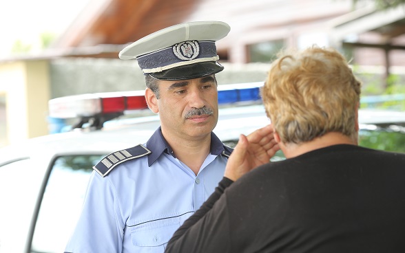 A policeman listening to a resident